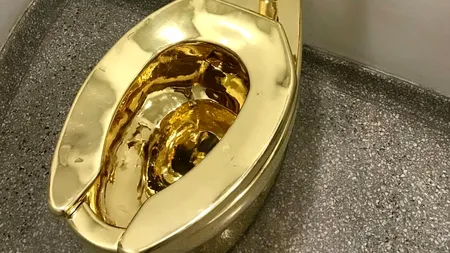 Celebra toaletă din AUR a fost vândută pentru 12,1 milioane de dolari. Este o replică a operei de artă a lui Cattelan