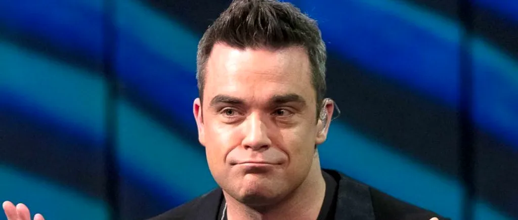 Robbie Williams a căzut peste o femeie și i-a rupt mâna, în timpul unui concert