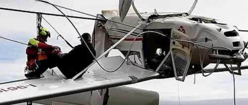„Dacă avionul s-ar fi prăbușit direct pe pământ...:  Un pilot și pasagerul lui au supraviețuit ca prin minune după ce avionul a rămas blocat în cabluri unei telecabine - VIDEO 