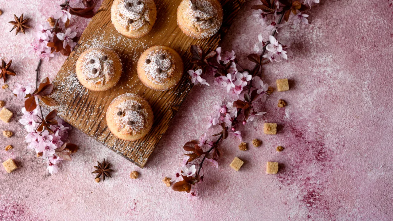 Fresh baked cupcakes of rice flour with banana and vanilla with a mug of hot chocolate 