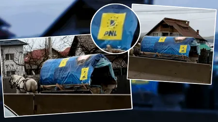 Imaginile zilei surprinse pe un drum național. O căruță acoperită de un banner electoral PNL se târâie prin ploaie