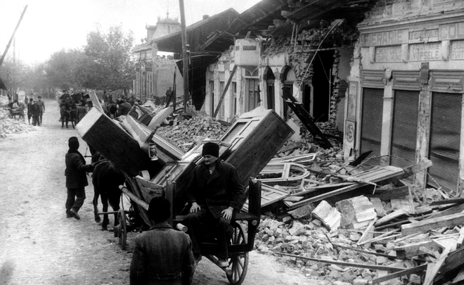 Romanian peasants of the village of Panciu, Romania on Nov. 29, 1940, carry away possessions salvaged from their shattered homes following a large earthquake.,Image: 598816306, License: Rights-managed, Restrictions: This content is intended for editorial use only. For other uses, additional clearances may be required., Model Release: no