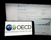 OCDE își revizuiește previziunile privind economia globală a doua oară în acest an, citând IMPACTUL politicilor tarifare ale lui Trump