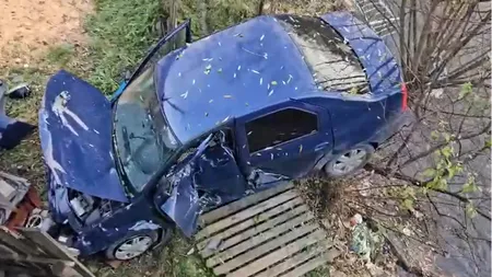 FOTO-VIDEO | Accident violent în Argeș: Un șofer s-a răsturnat cu mașina de pe un pod. A rămas suspendat pe malul unui râu