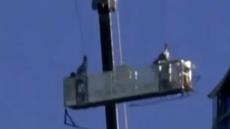 Ca într-un carusel al morții. Doi spălători de geamuri s-au balansat printre zgârie-nori din cauza vântului puternic- VIDEO