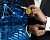MIȘCARE uriașă în zona cripto. Compania care a achiziționat cea mai mare platformă de tranzacționare de bitcoin / Peste 100 de milioane de utilizatori