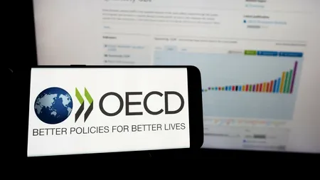 OCDE își revizuiește previziunile privind economia globală a doua oară în acest an, citând IMPACTUL politicilor tarifare ale lui Trump