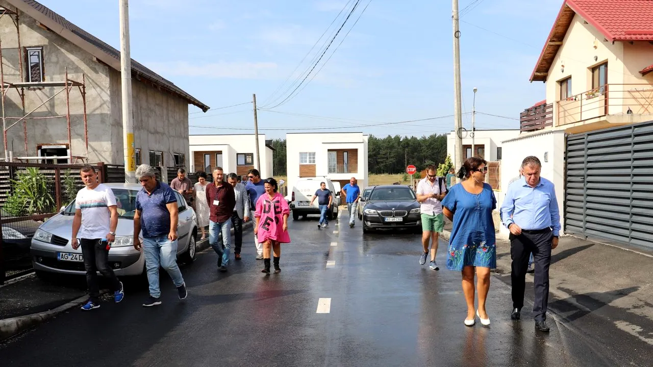 Locuitorii unui cartier rezidențial din Pitești au deschis sticlele cu șampanie, după ce li s-a asfaltat strada pe care locuiesc. De zece ani așteptau acest eveniment (FOTO)