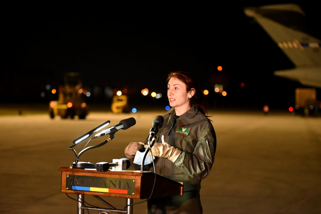 Pilotul român Simona Măierean, membru al echipajului, adresându-se audienței la sosirea celui de-al treilea transport aerian cu echipamente medicale din Coreea de Sud, în 10 aprilie – Sursa: MApN -Laurențiu Turoi